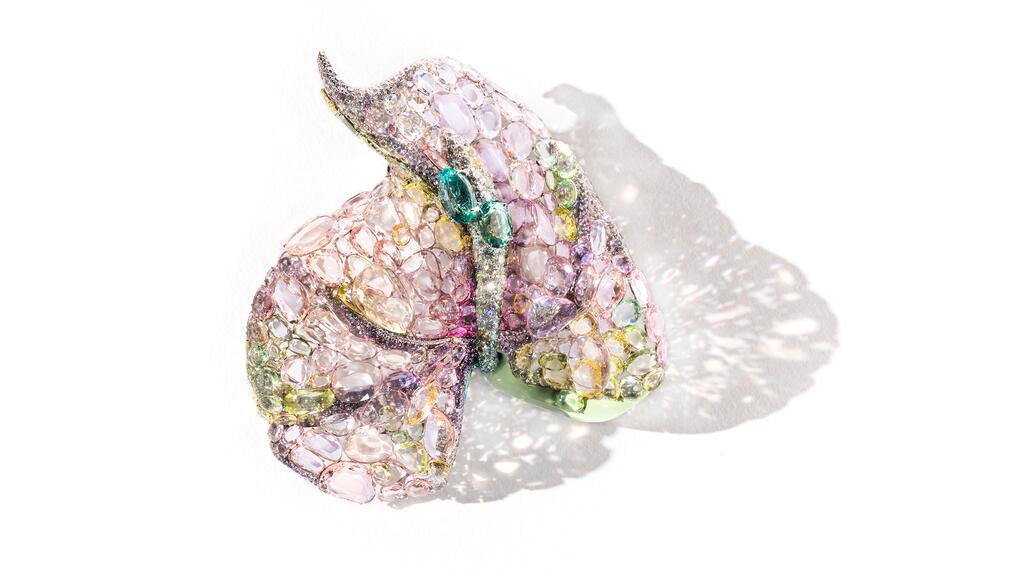 Feng J’s titanium and 18-karat gold “Pink Anthurium” brooch features greenish and bluish tourmalines, morganites, double rose-cut tsavorites, chrysoberyl, yellow quartz, pink and grayish-green sapphires, and white diamonds. Feng J’s “Pink Anthurium” brooch